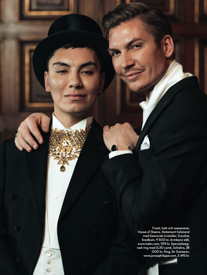 Formal portrait featuring elegant black tie attire and ornate gold statement necklace.