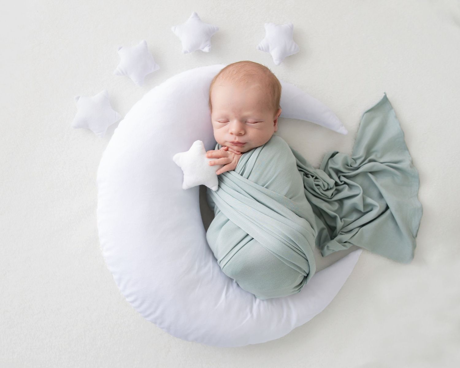 A series of newborn photography portraits featuring a baby with brown teddy bears and soft white fabric backdrops.