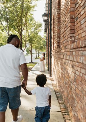 Walking sequence along a brick wall on a sunny sidewalk.
