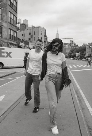 Black and white sequence of playful walking poses on a city sidewalk.