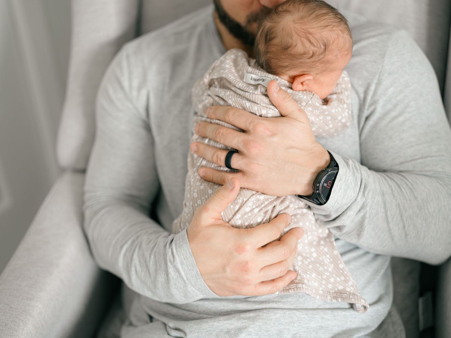 Father and newborn photographed at home in Monmouth County NJ with natural window light.