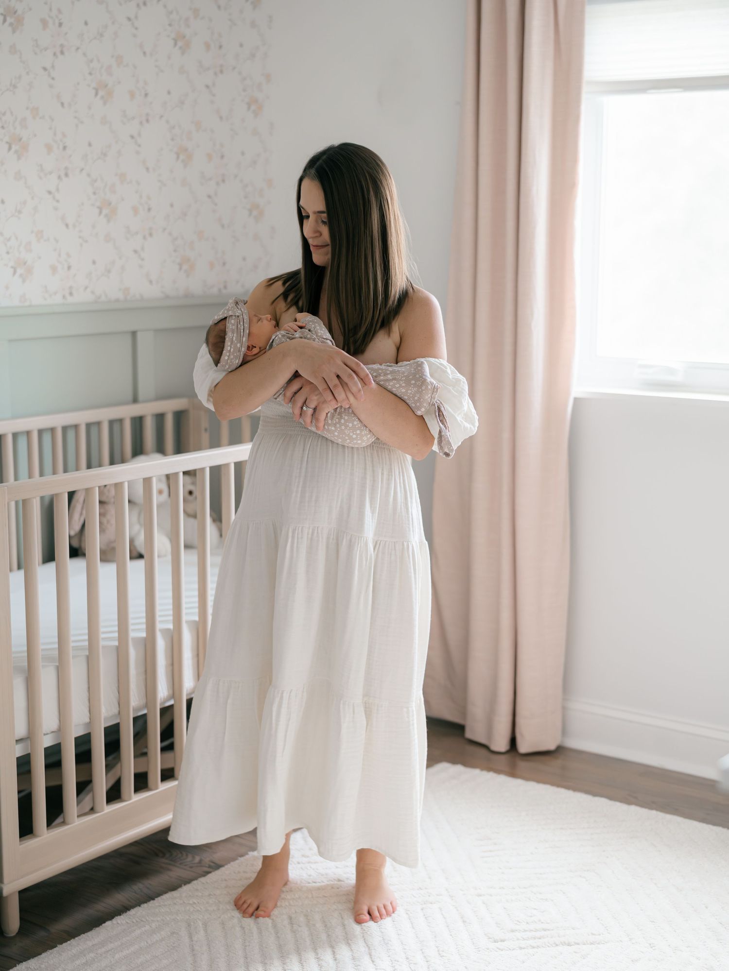 Mother holding her newborn during an in-home newborn photography session in Monmouth County NJ.