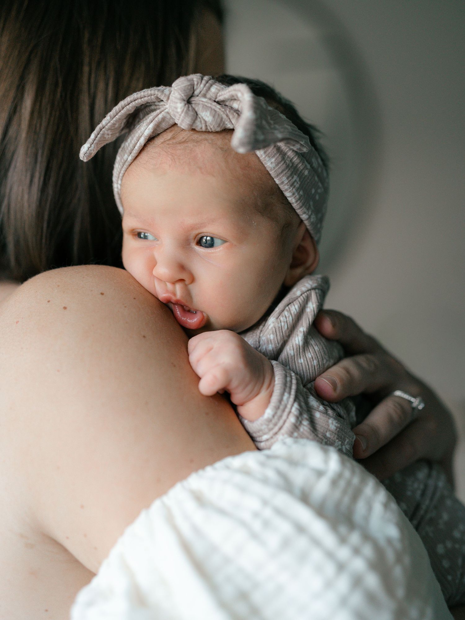 Lifestyle newborn photography in a Monmouth County NJ home with soft natural light.