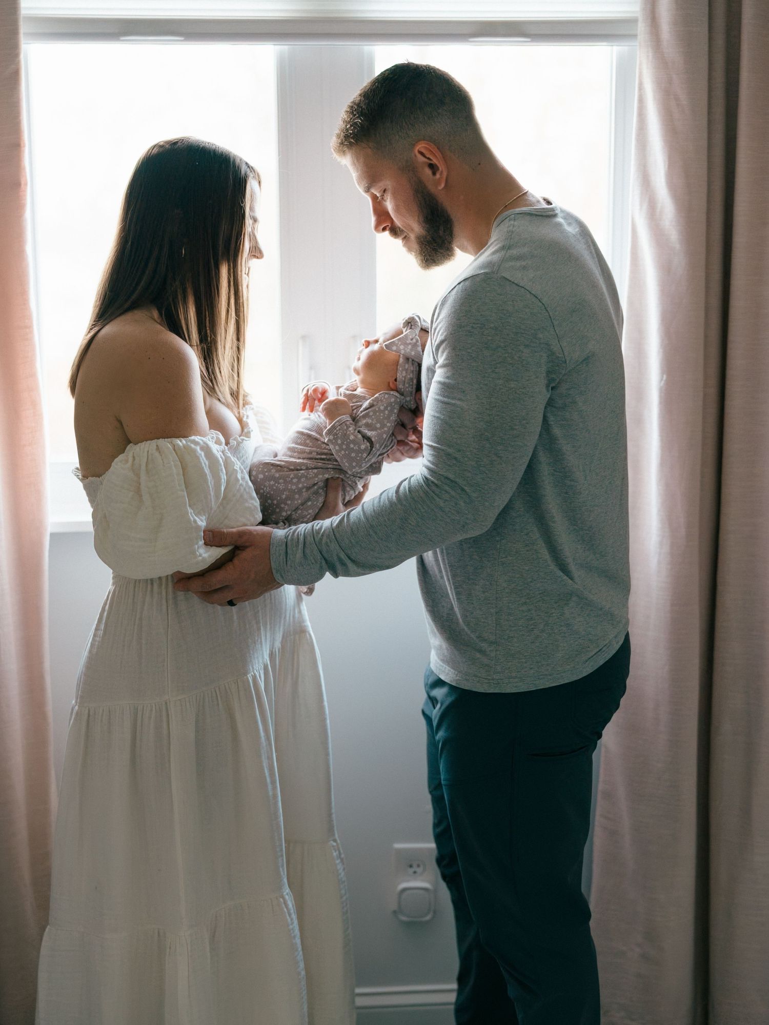 Newborn photographed in a sun-filled nursery during an in-home Monmouth County newborn session.