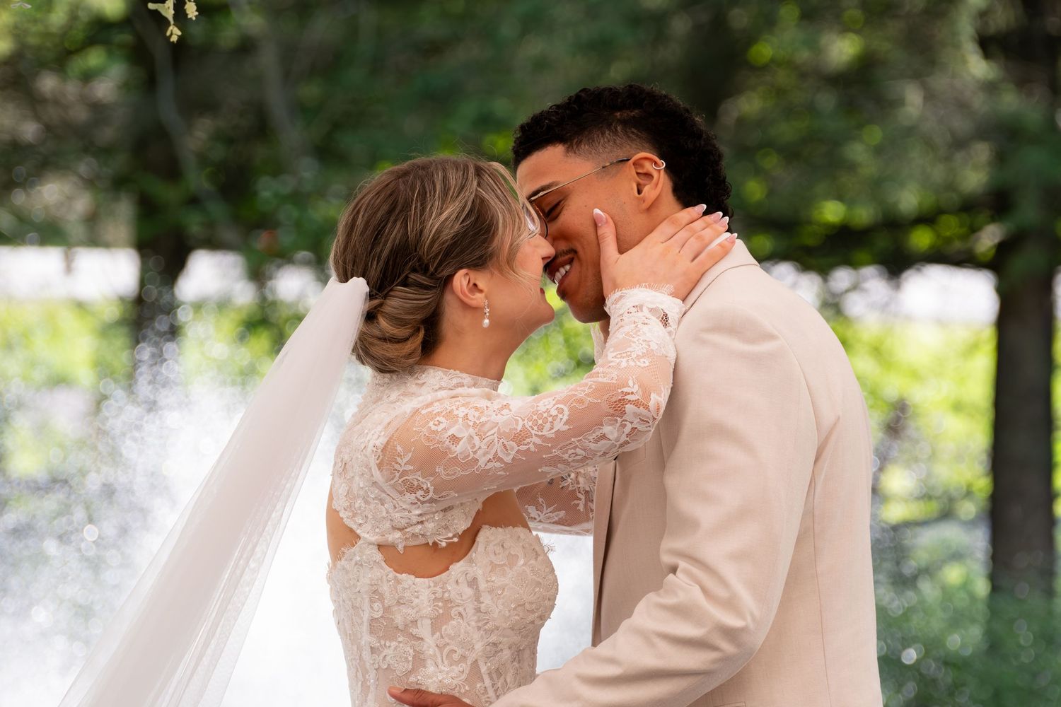 Wedding celebration outdoors with elegant formal attire and joyful expressions.