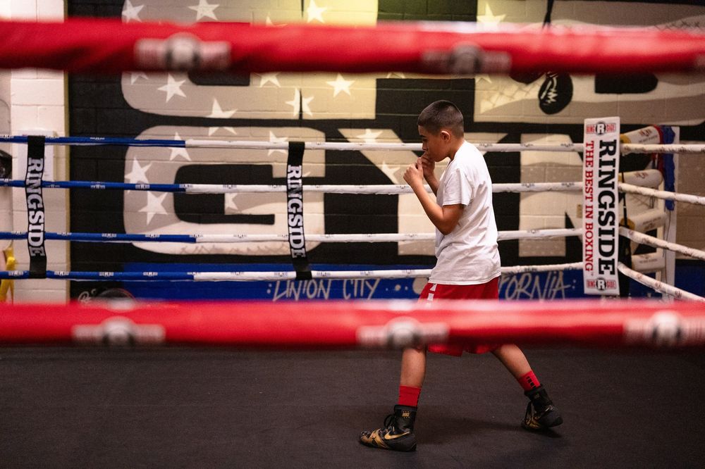 Boxing ring ropes and corner posts shown in detail at an indoor sports facility.