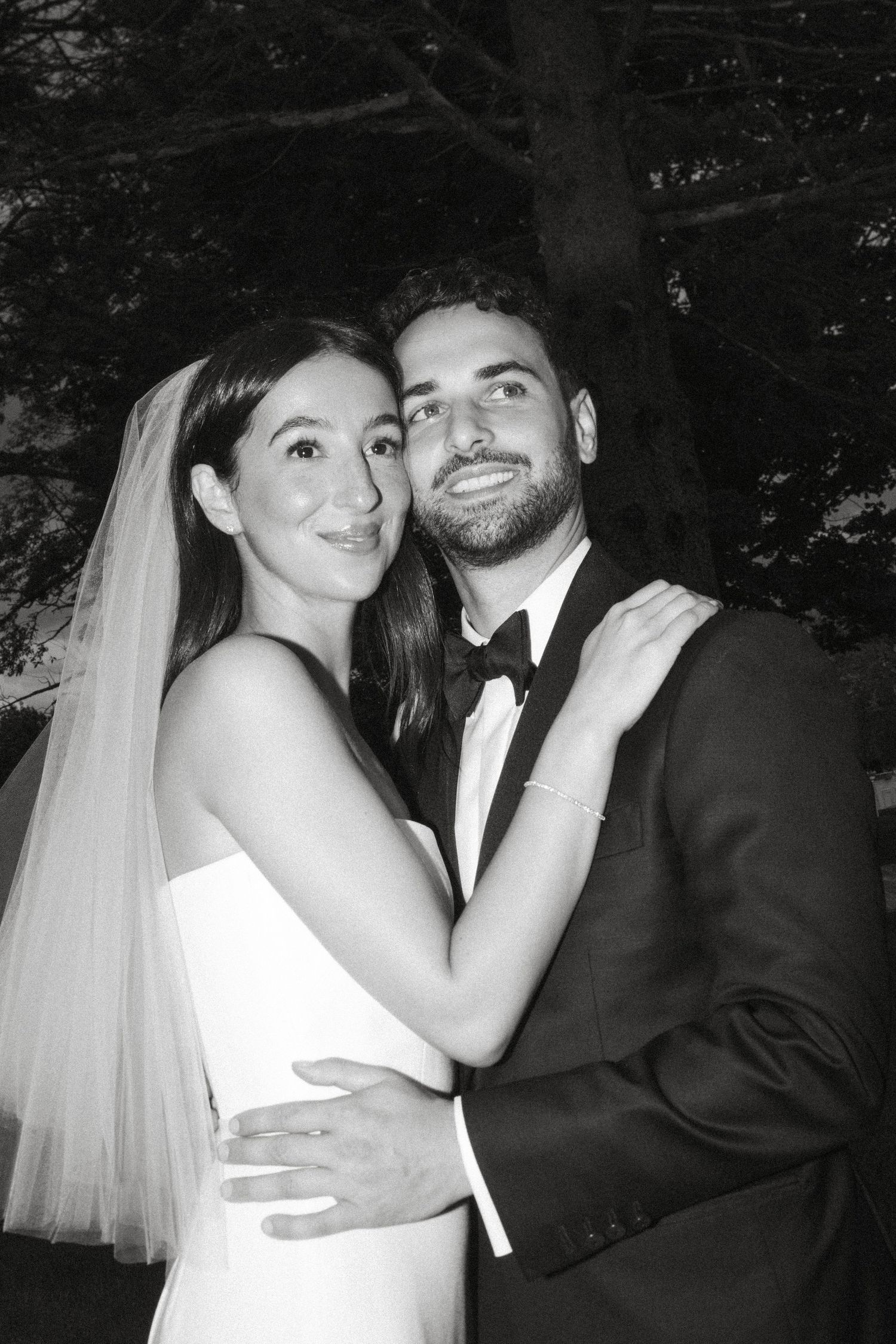 Black and white wedding photos show intimate moments between newlyweds in romantic poses.
