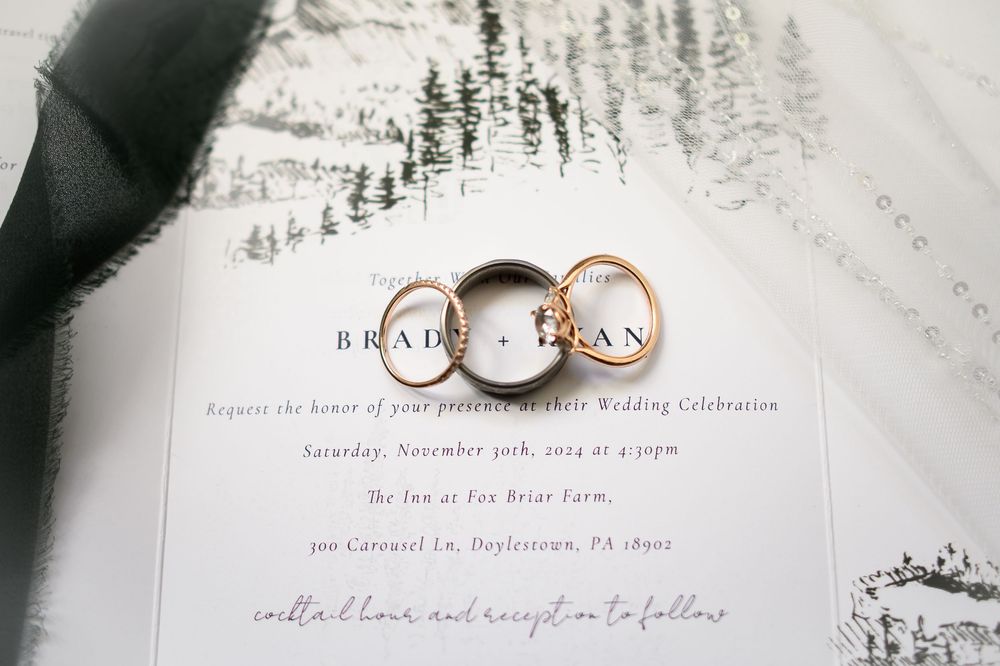 Wedding invitation details with elegant typography and pine tree illustrations on white paper.