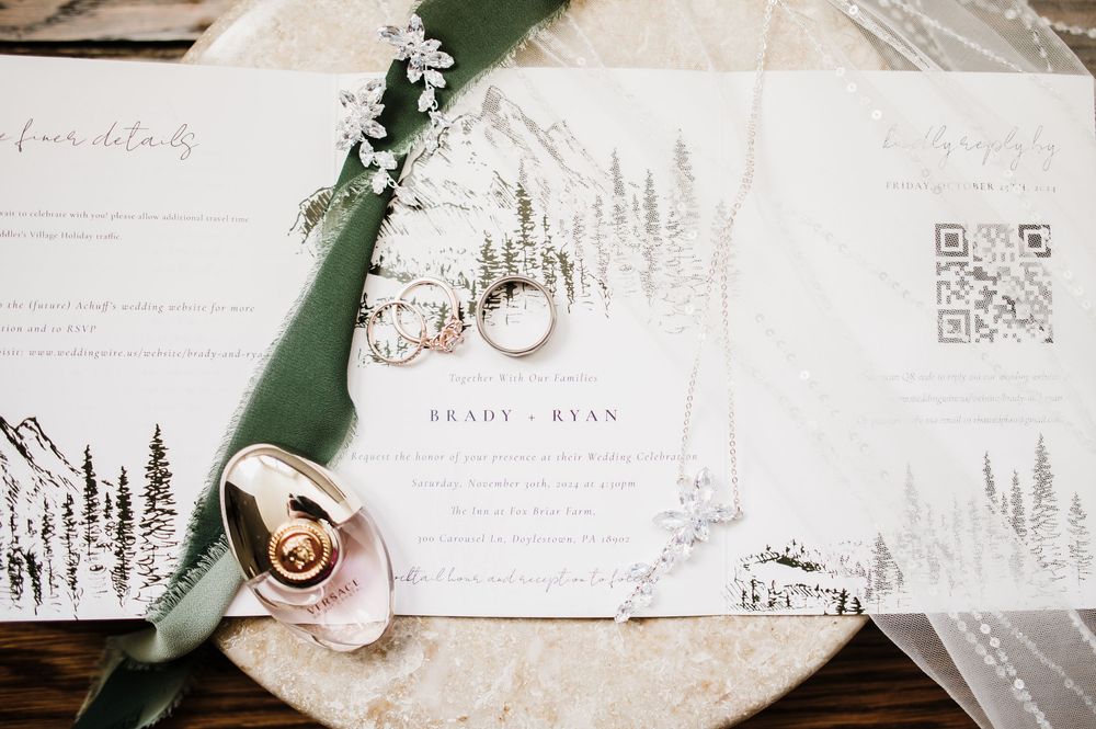 Wedding stationery suite featuring forest-themed designs and rose gold accents.