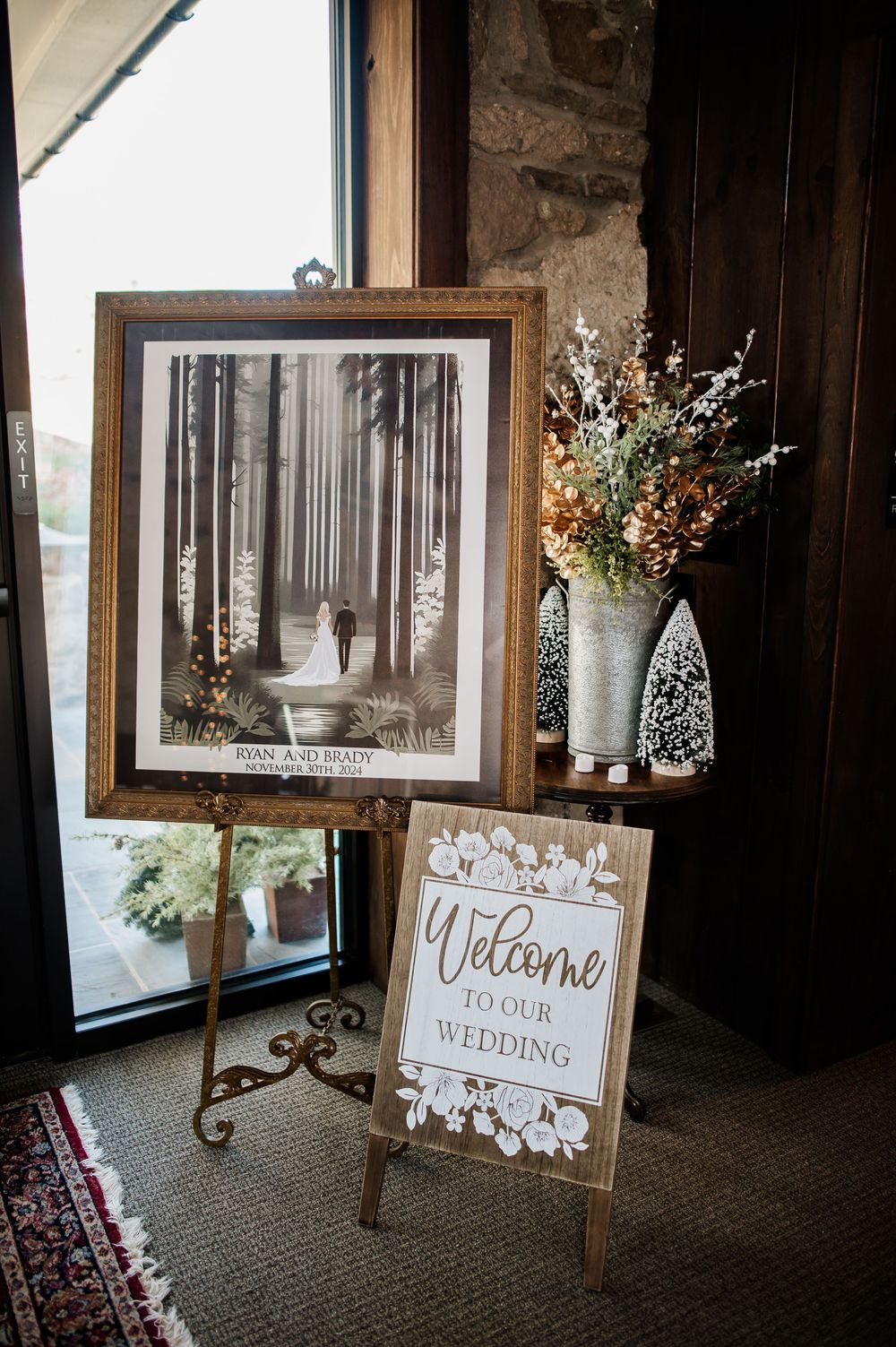 Vintage-style welcome signs and framed artwork in a rustic venue with natural lighting.