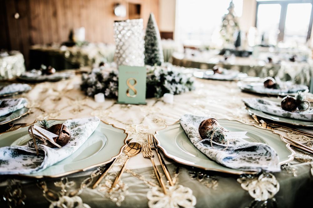 Elegant table settings with silver chargers and crystal glassware at a formal event.