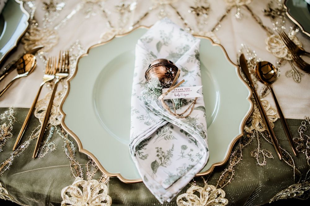 Delicate place settings featuring mint green plates and lace details on a white tablecloth.