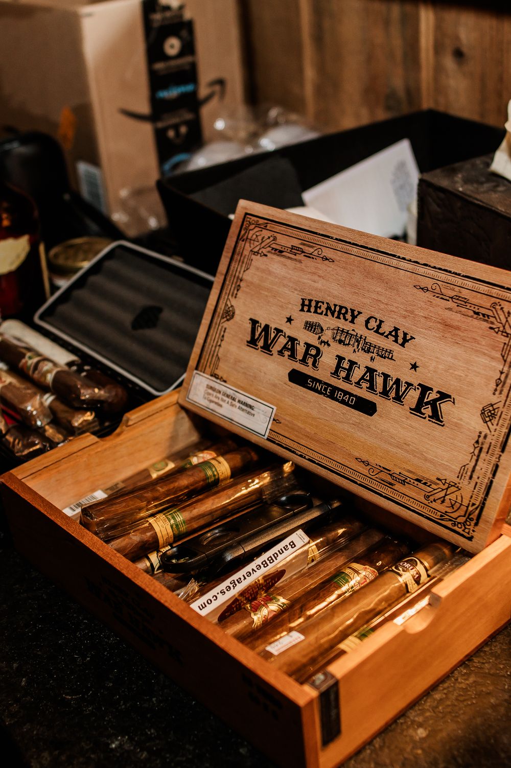 Vintage wooden cigar boxes displaying Henry Clay cigars in an antique arrangement.