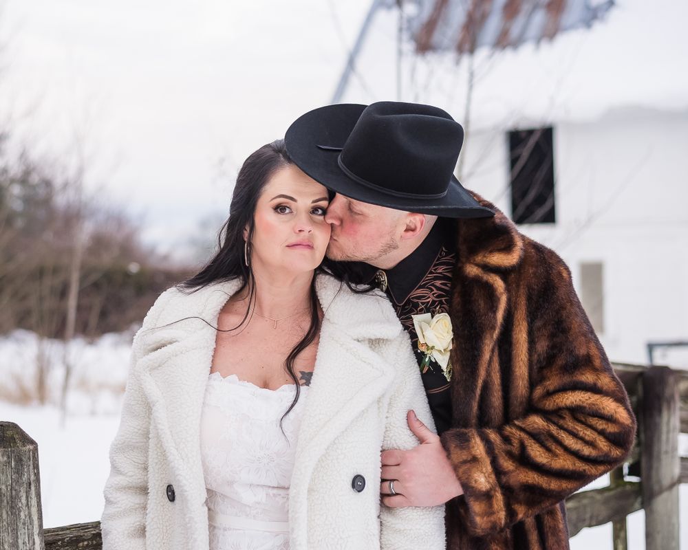 A groom lovingly kisses his bride on the cheek. Photo taken at Estate 248 in Aldergrove, BC.