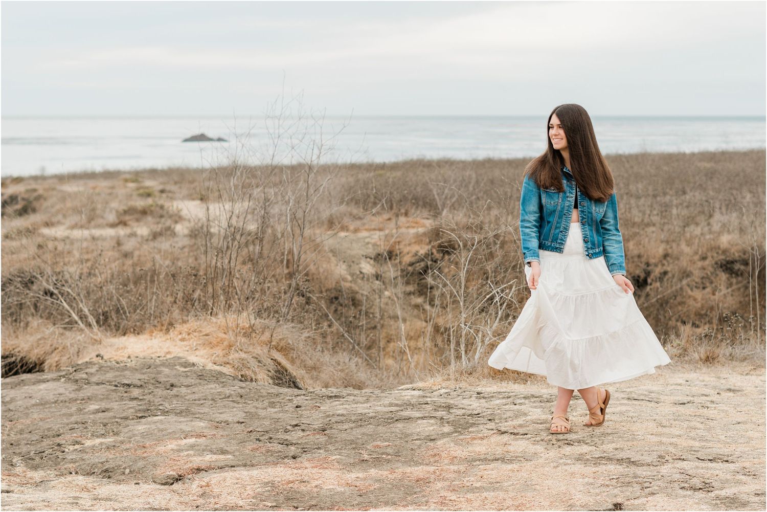 San Luis Obispo Senior photographer slo high senior session on the bluffs off of highway 1 in white flowy skirt and jean jacket