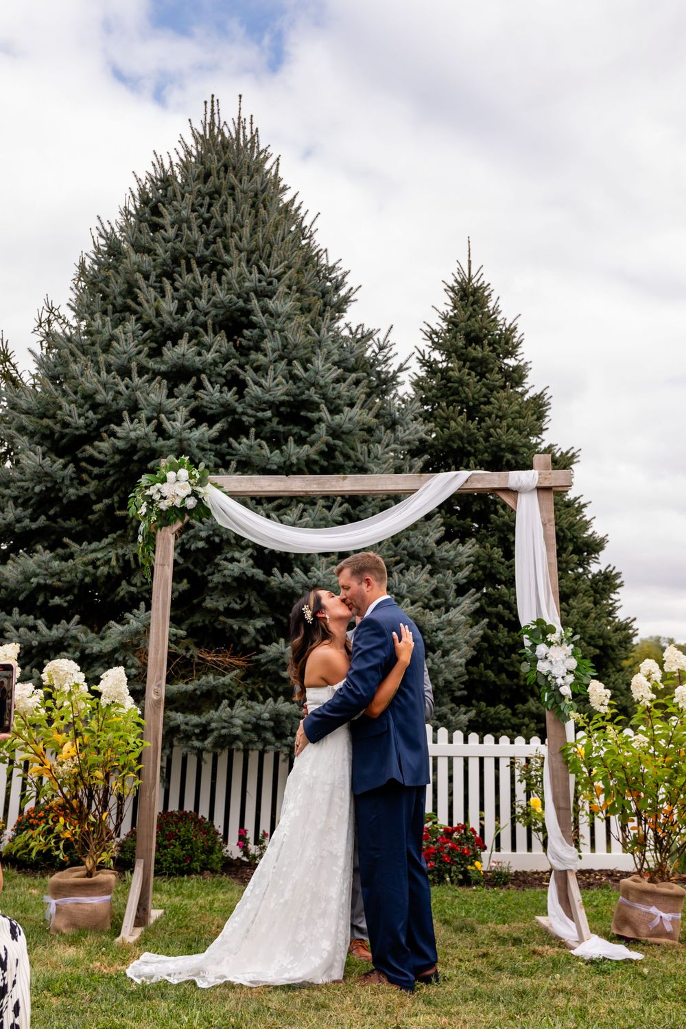 First Kiss at backyard wedding garden ceremony in Omaha, Nebraska. - BrightSide Photography
