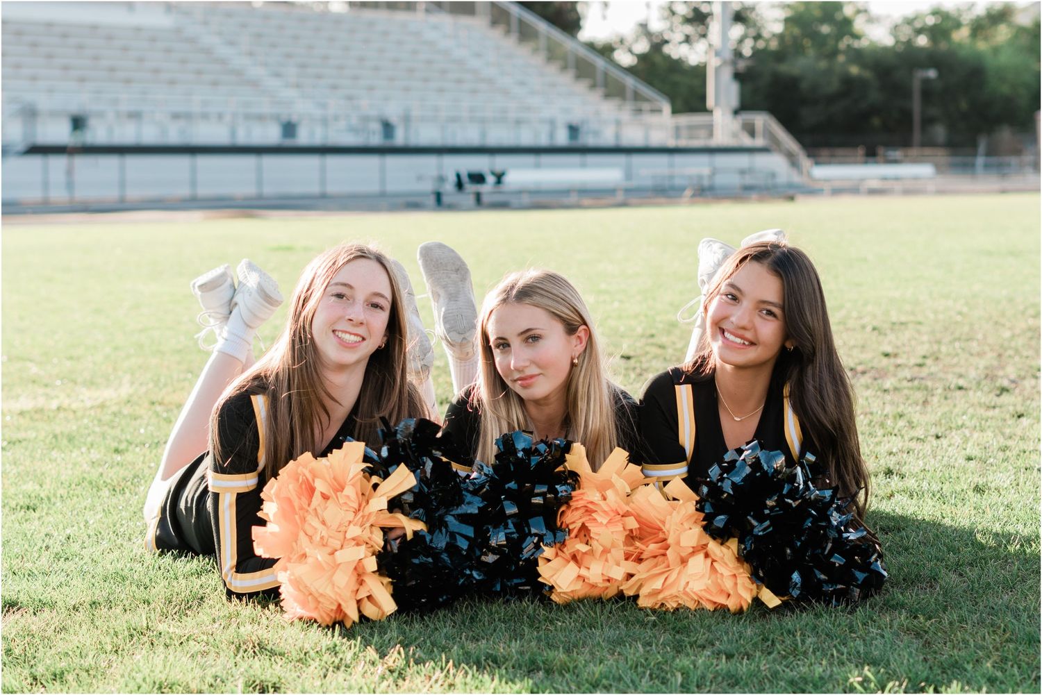 SLO High Varsity Cheer, team photos with cheerleaders laying down with pom poms