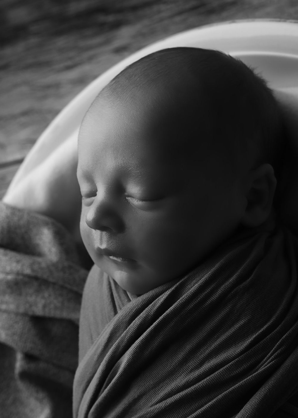 A timeless black and white portrait of a newborn, capturing the delicate features and peaceful essence of early life in a newborn photograph