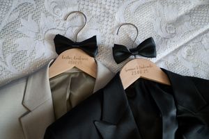 Black bow ties arranged in a row on white fabric creating an elegant formal pattern.