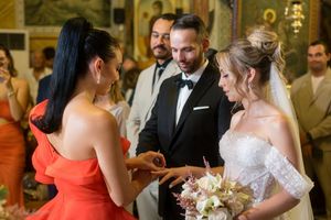 A wedding reception celebration showing guests dancing and socializing in an elegant indoor venue.