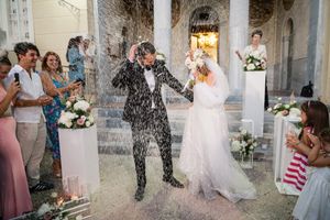Series of candid wedding moments captured in an outdoor courtyard setting with stone architecture.