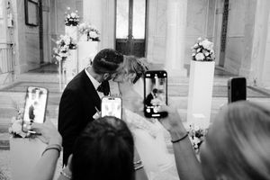 A black and white wedding photo sequence showing a couple exchanging rings during their ceremony.