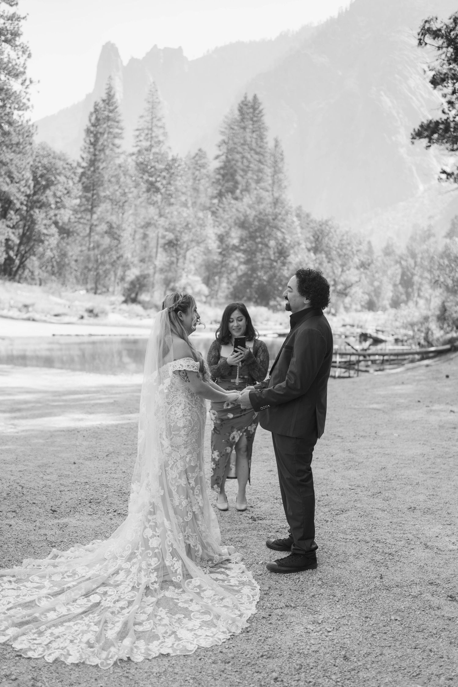 Black and white photo of elopement ceremony by Merced River in Yosemite Valley.