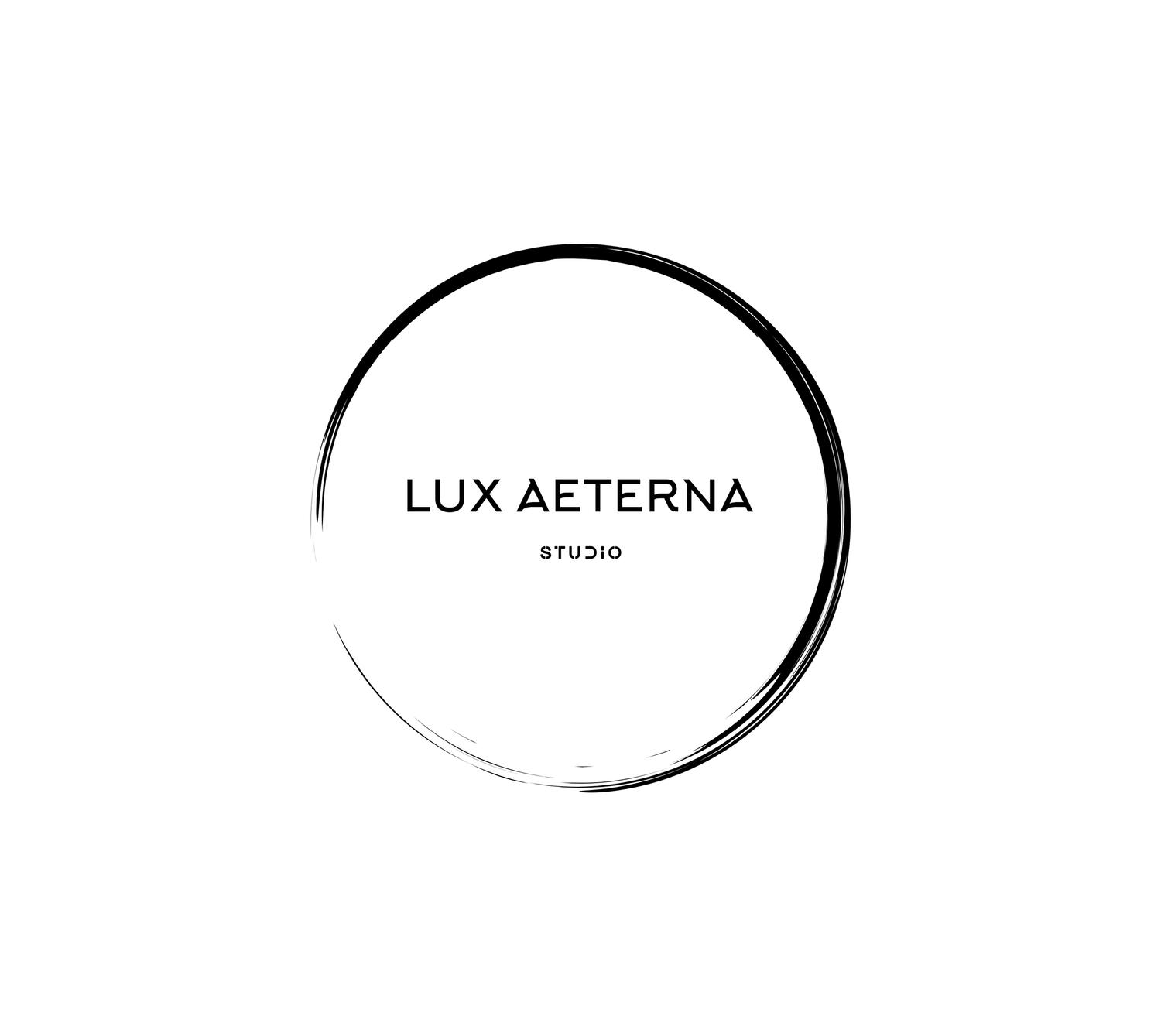Lux Aeterna Studio minimalist logo with elegant black brushstroke circle on white background.