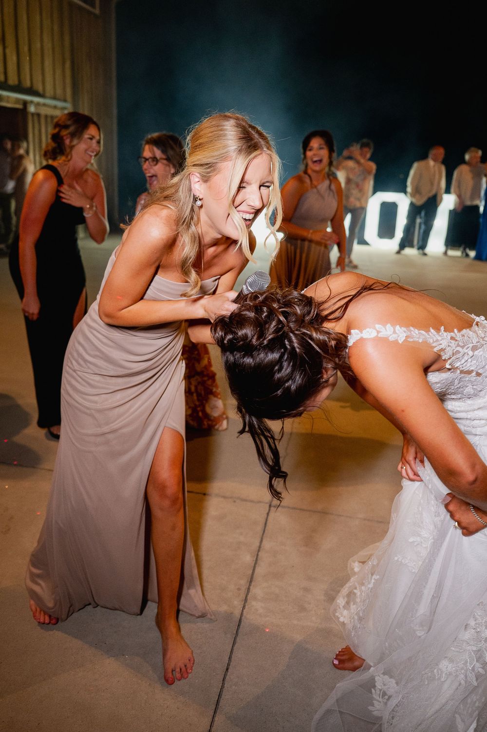 Wedding guests performing dance moves during a lively reception celebration.