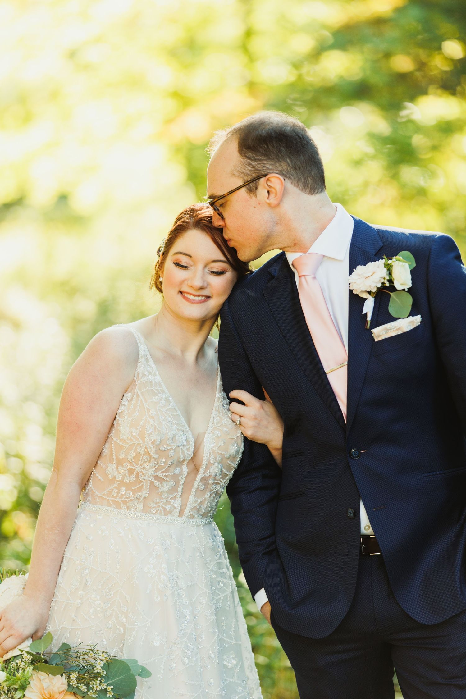 Intimate wedding moments captured in a sun-drenched forest setting.