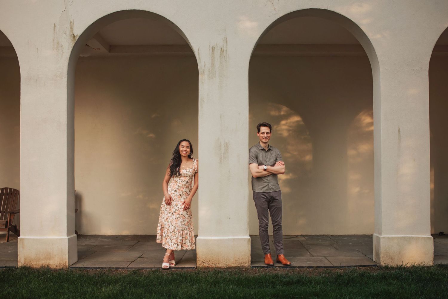 People posing for photos in a series of arched walkways at sunset creating a dynamic visual sequence.