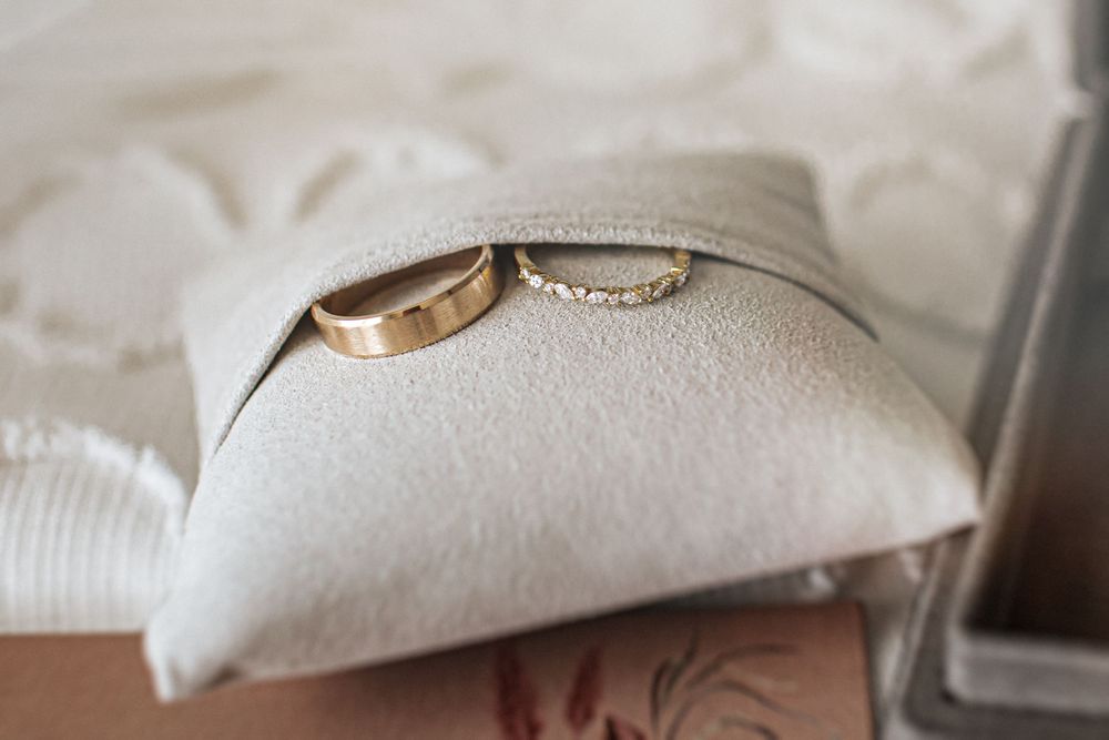 A stack of fluffy white pillows and bedding arranged on a bed.