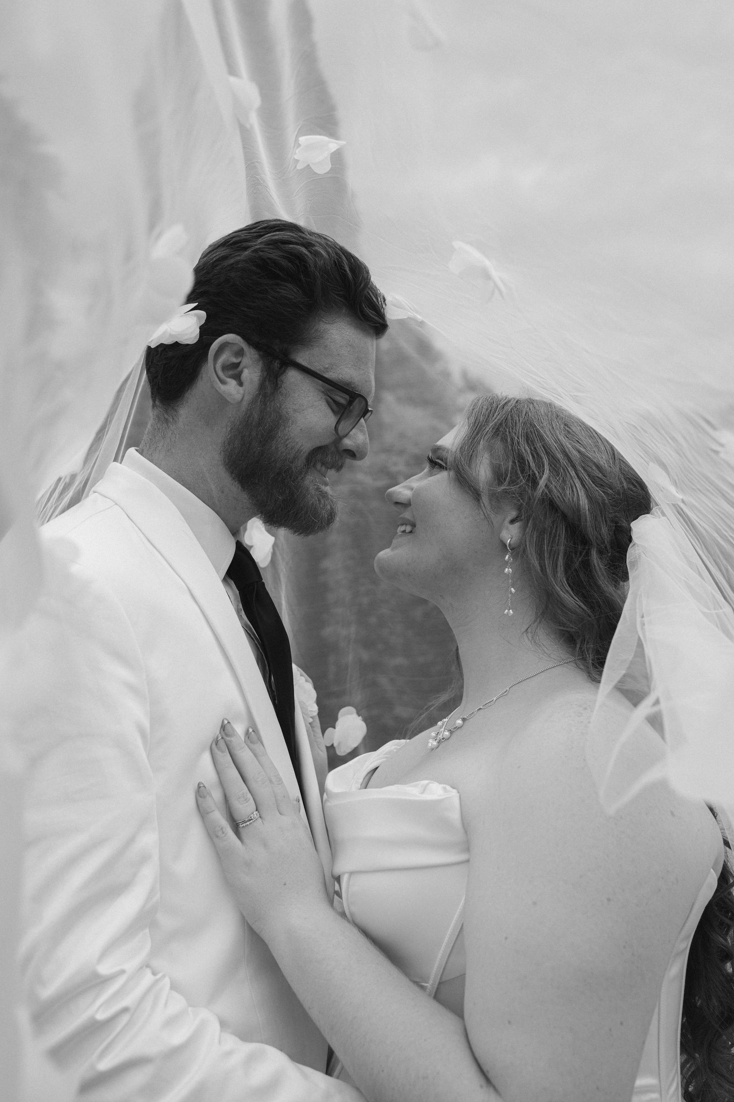 The bride is putting a flower on her groom's jacket before the wedding ceremony