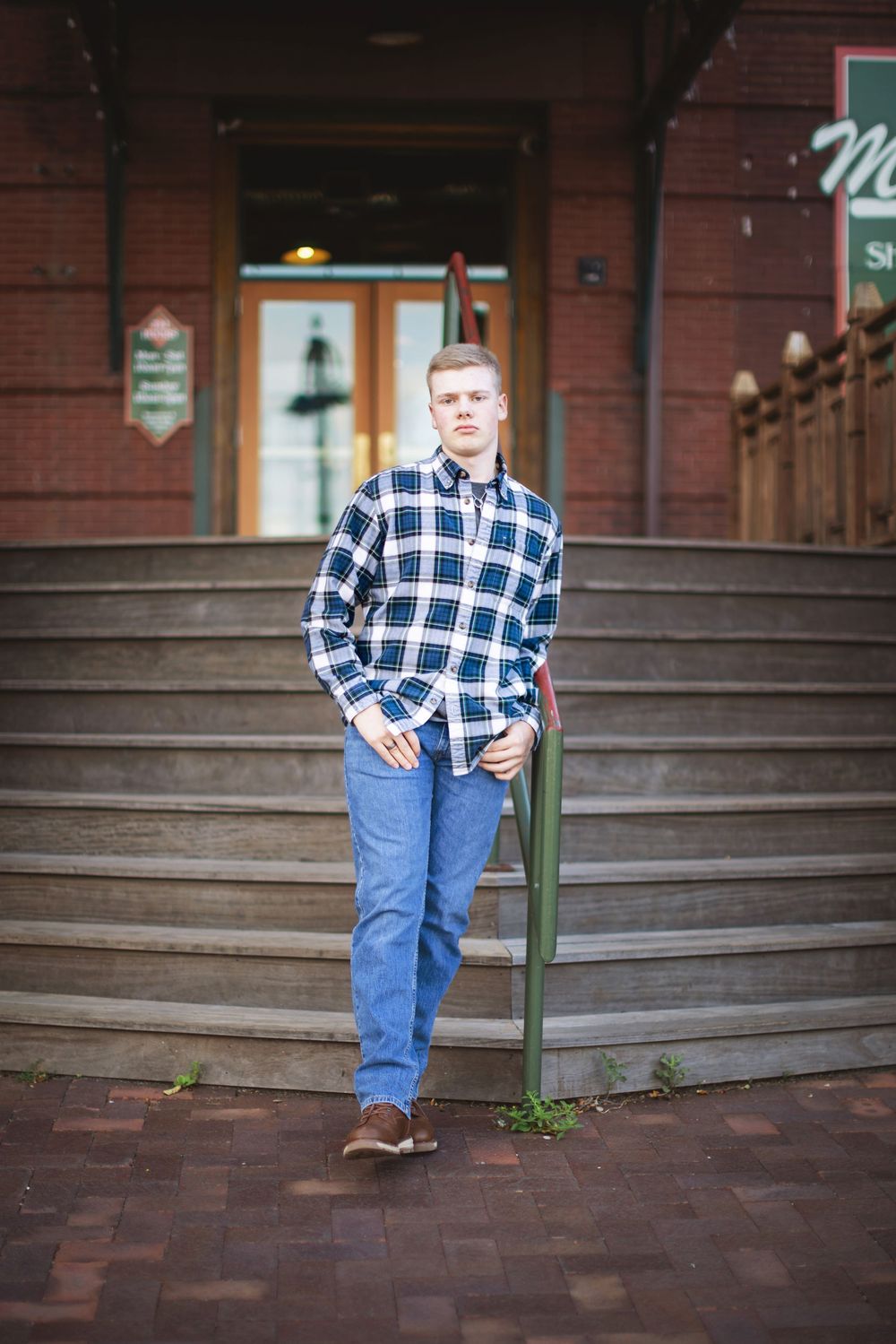 A series of three photos showing a person in a plaid shirt and jeans posing on brick steps outside a building.