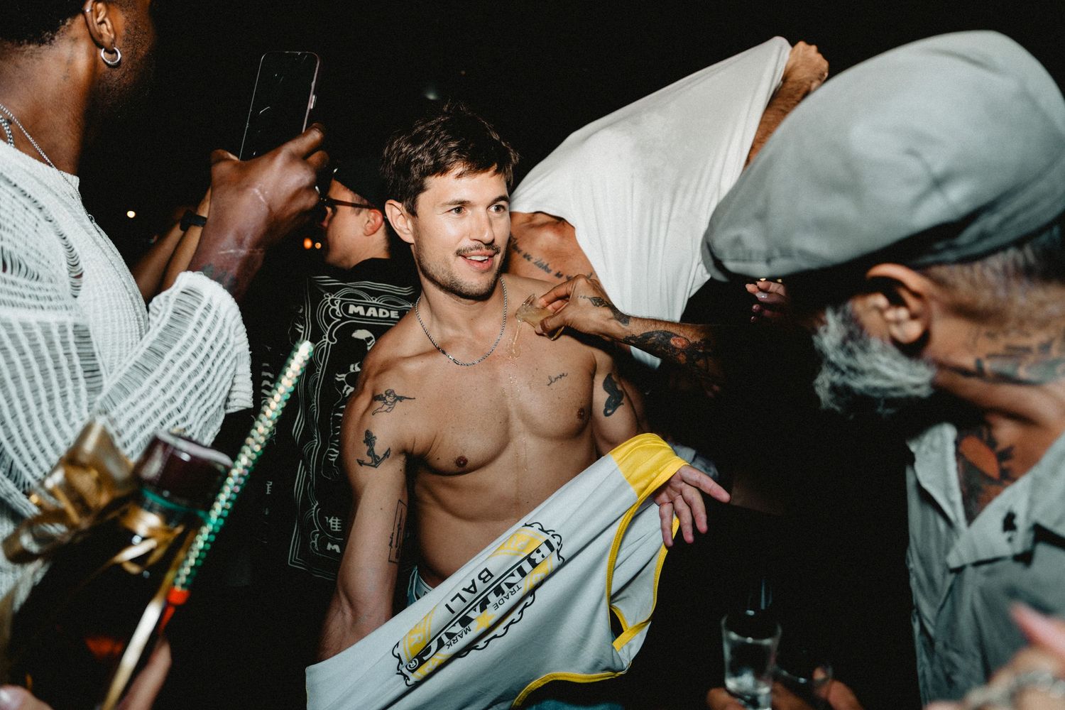 A group of people dancing and enjoying themselves at a crowded nightclub or party venue.