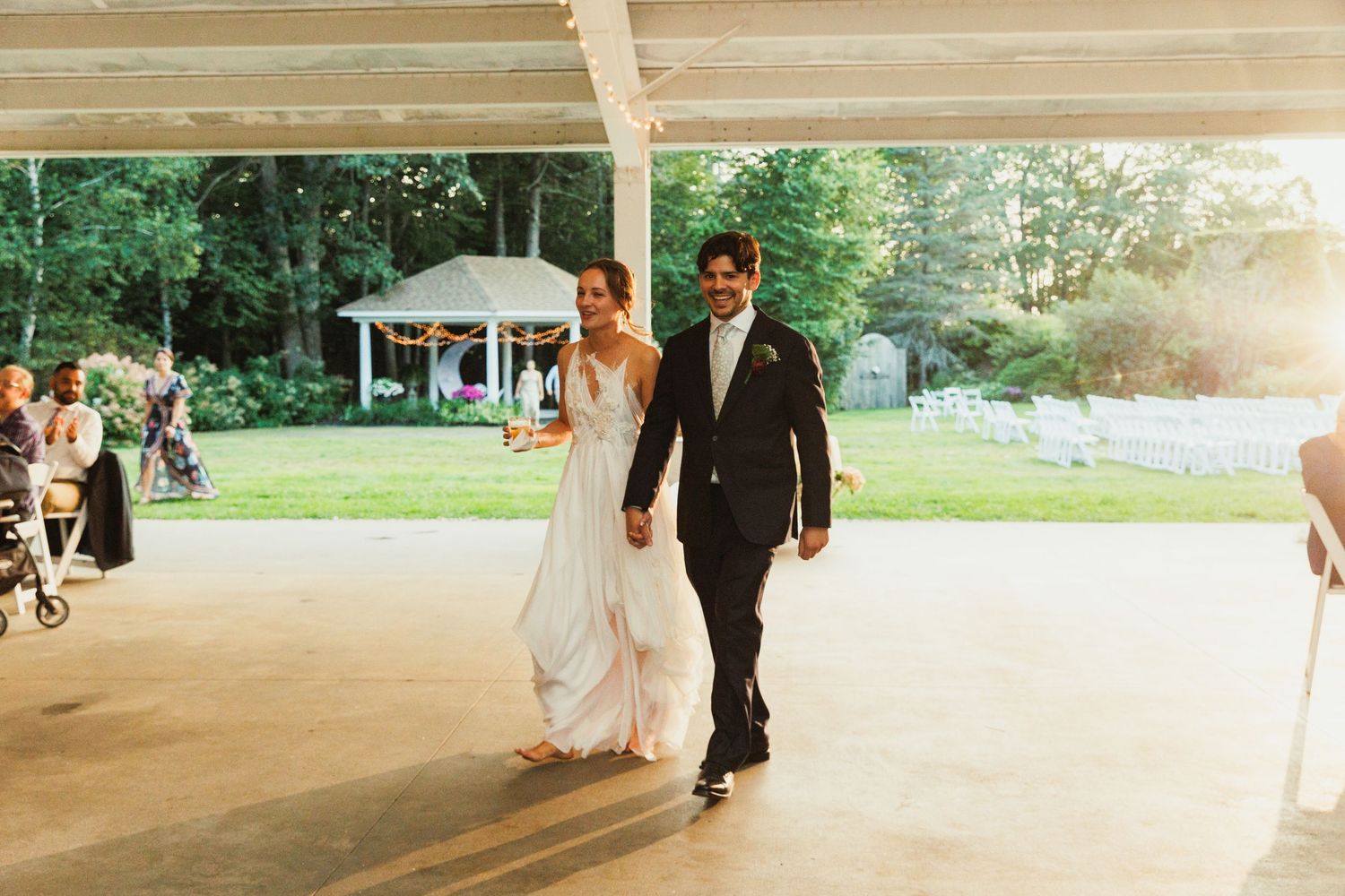 Outdoor wedding venue with white pavilion and natural greenery.