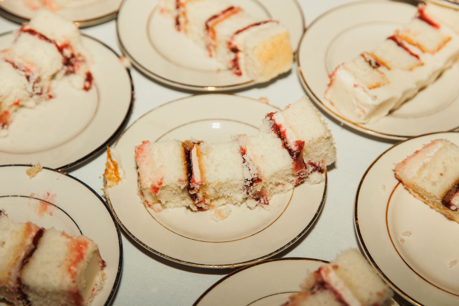 Used plates with cake crumbs arranged on a table after wedding reception.