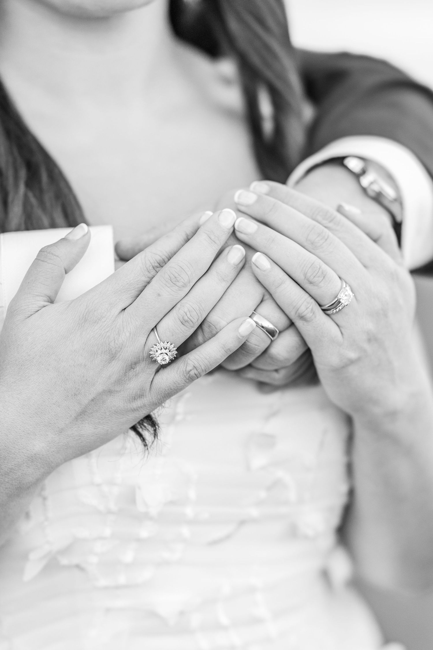 Black and white photo series showing close-up shots of hands exchanging wedding rings during a ceremony.