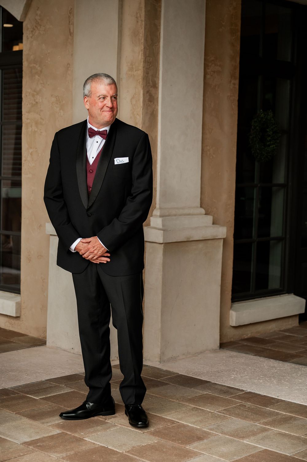 Wedding photo showing formal portraits taken under a columned portico.
