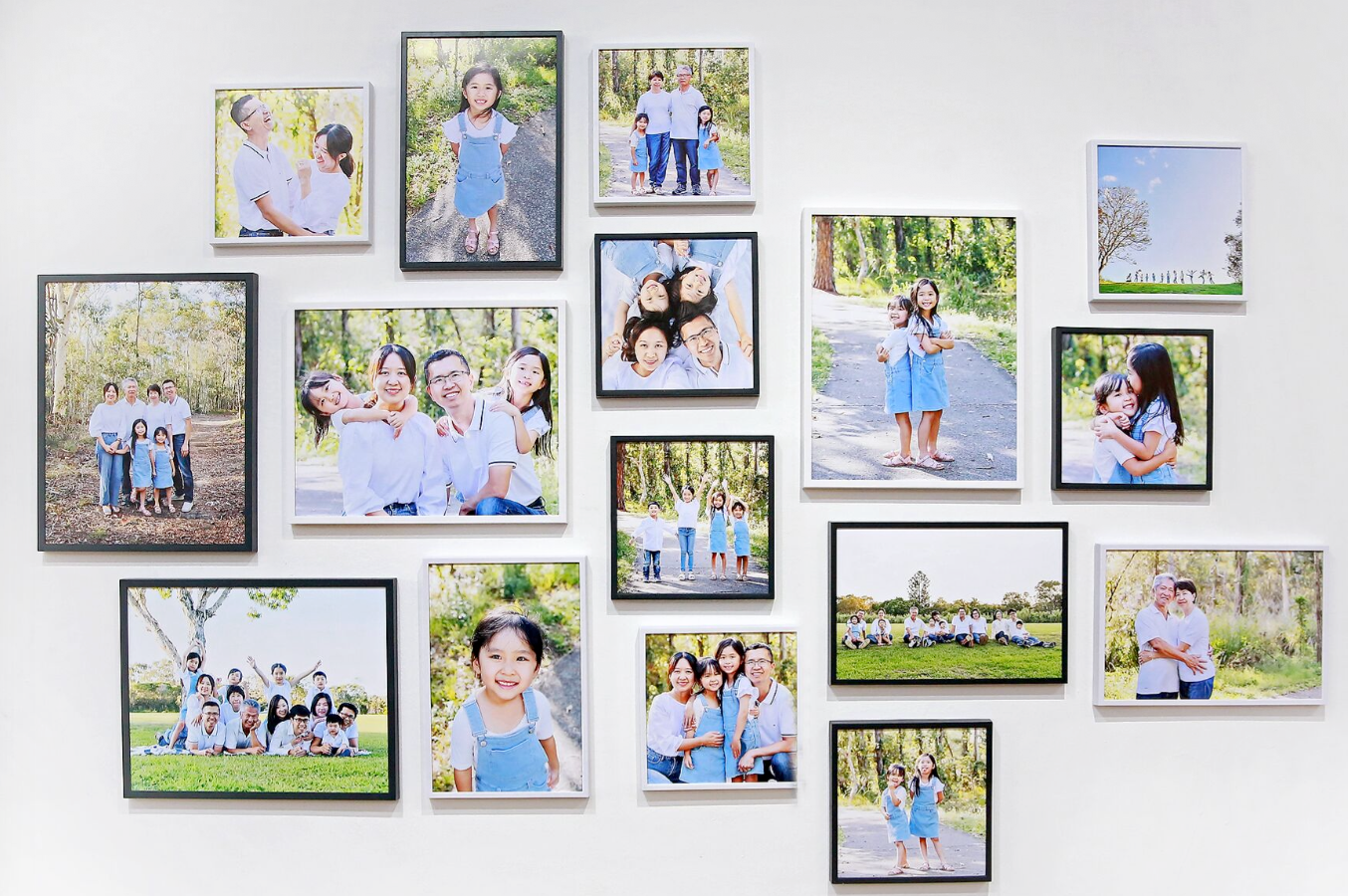Gallery wall display featuring multiple framed family photographs arranged in a creative layout.