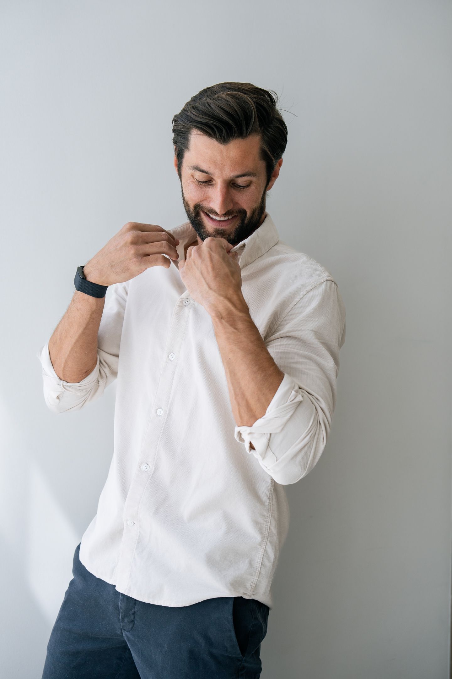 Creative branding portrait of male professional adjusting collar