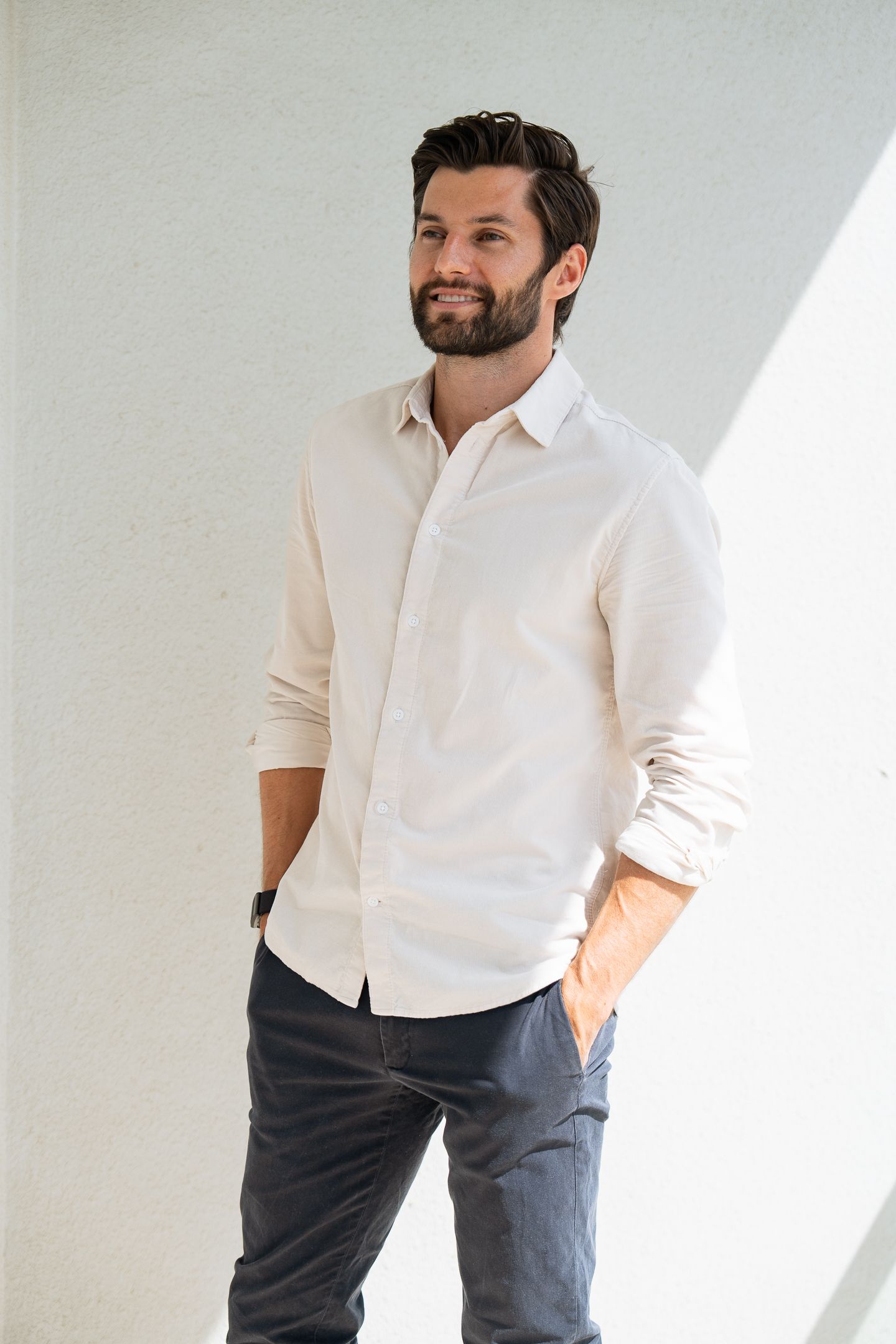 Full-length branding photo of businessman in casual white shirt