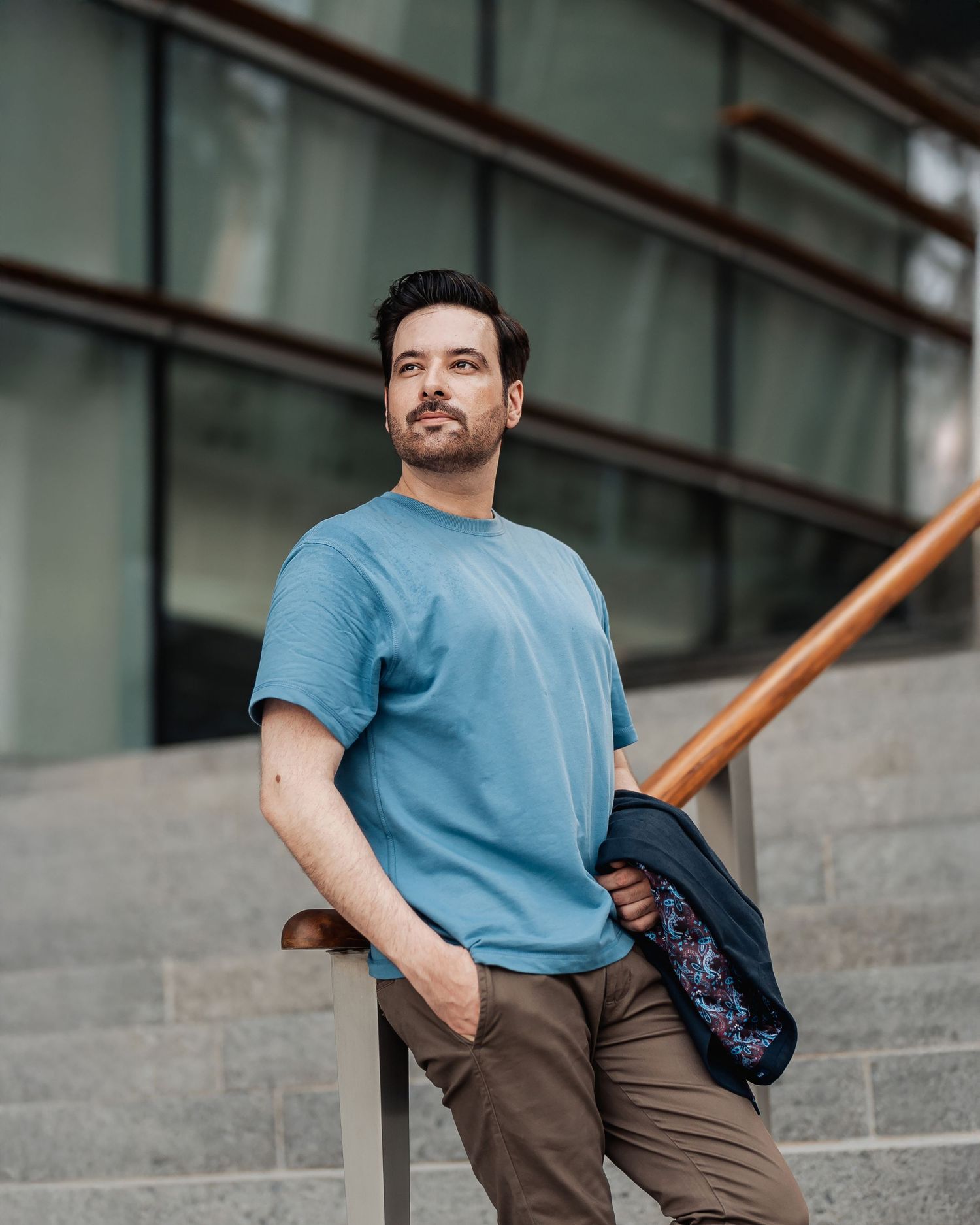 Professional portrait of businessman seated on city steps