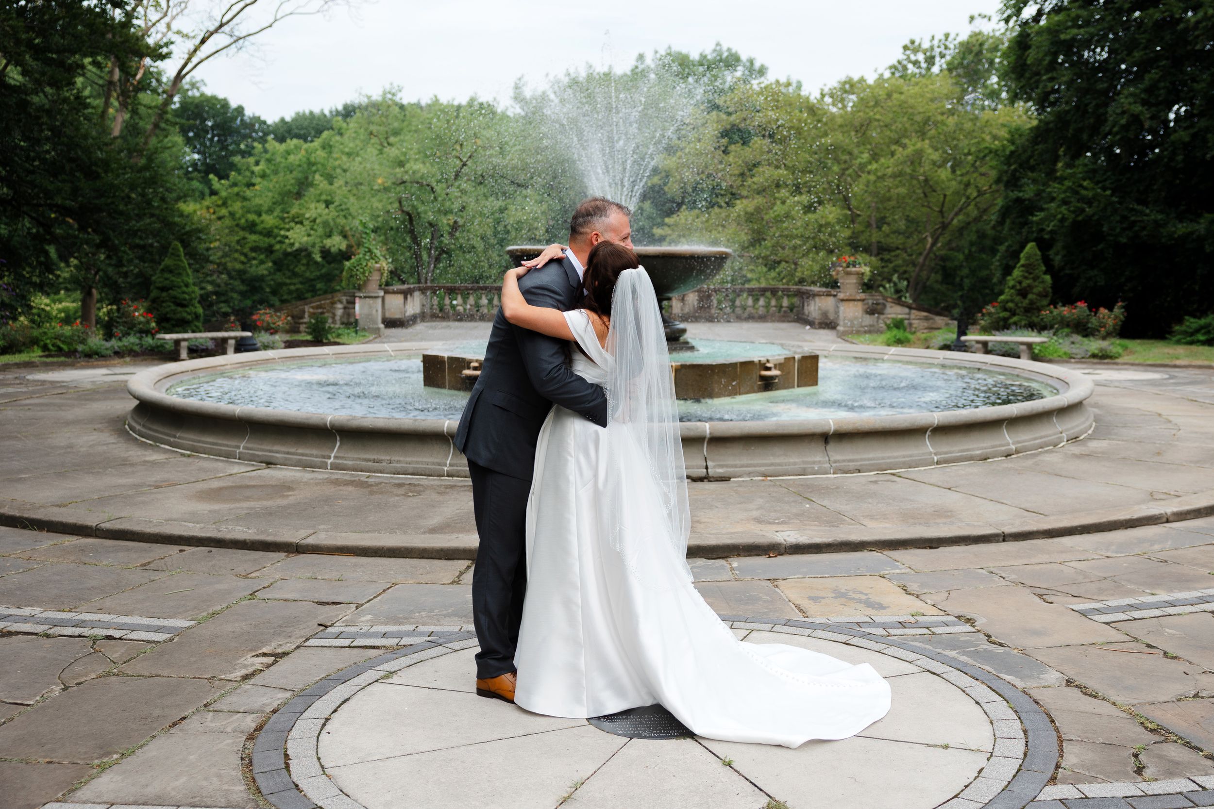 Bride and groom embracing at Cleveland Cultural Gardens on wedding day in Cleveland.