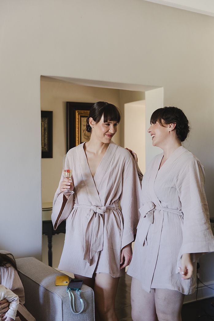 Bride and bridesmaid busy getting ready