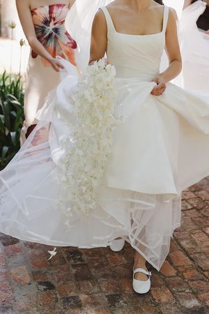 Close-up of the cascading orchid bouquet with textured white florals.