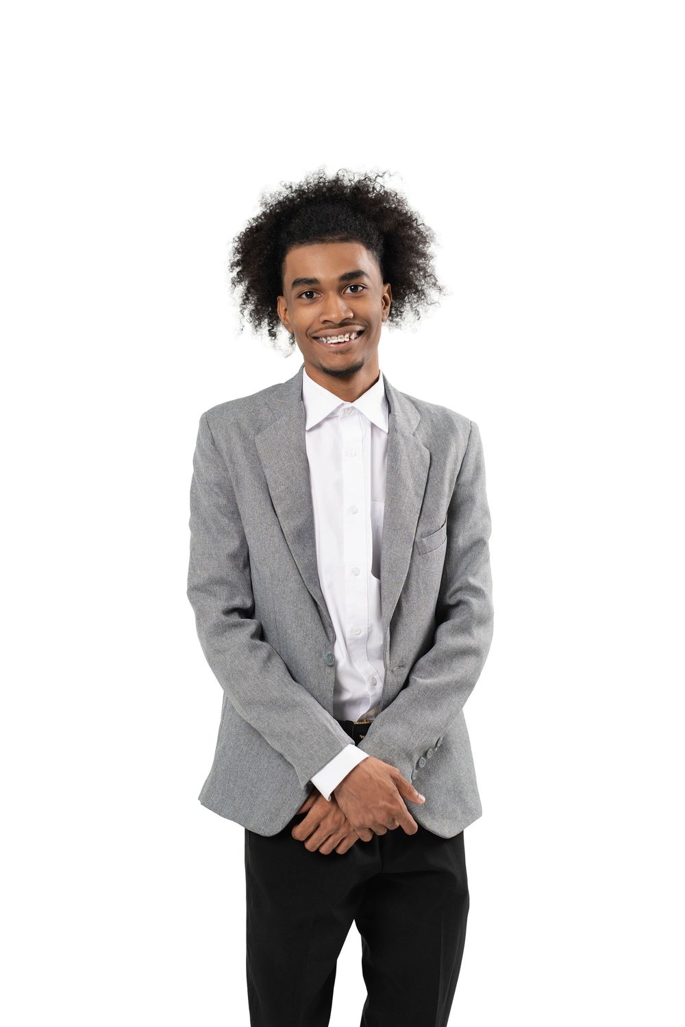 Professional wearing a gray blazer and white shirt smiles while standing against a white background.