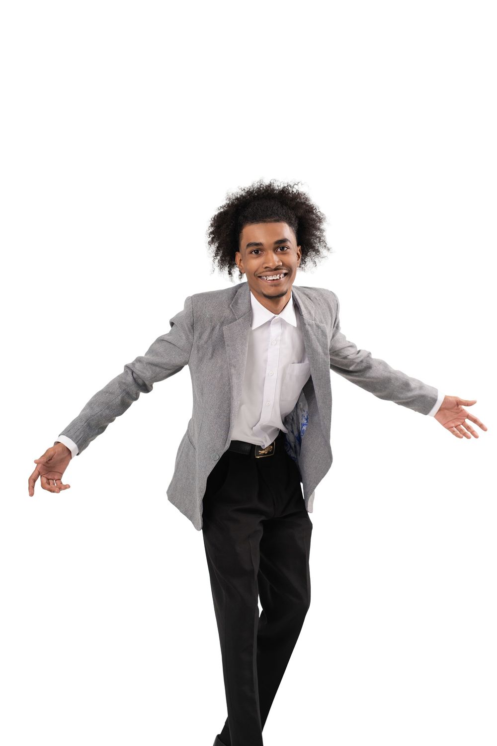 A person in business attire with a gray blazer and white shirt strikes a playful pose against a white background.