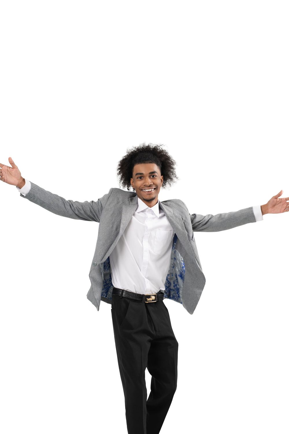 A person in professional attire jumps joyfully with arms spread wide against a white background.