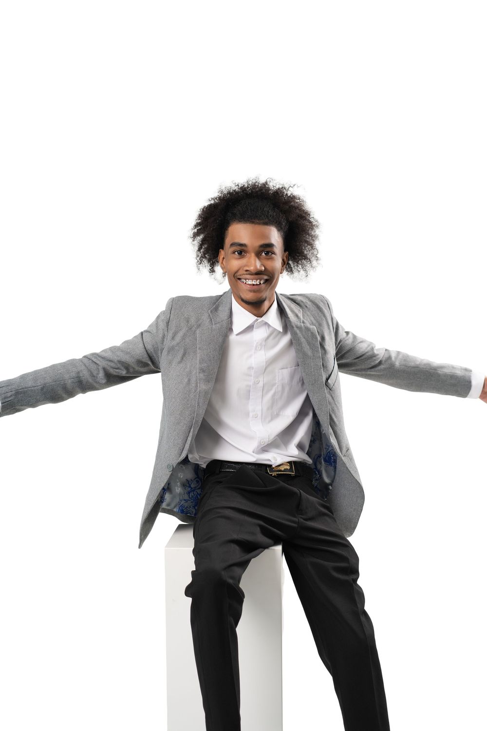 Dynamic performer in grey suit and white shirt strikes energetic dance poses in sequence against white background.